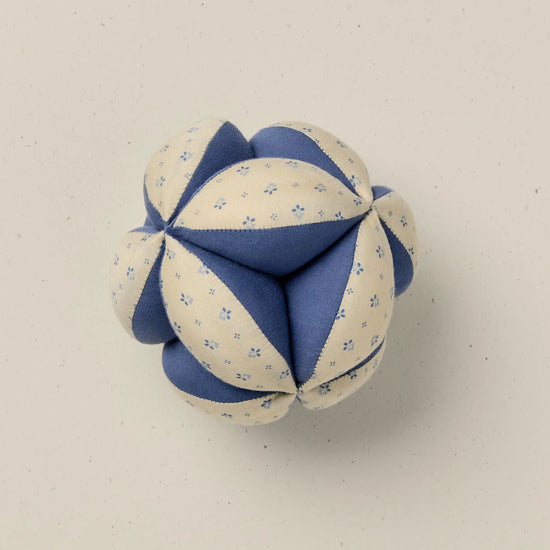 Blue and white fabric ball on a beige background