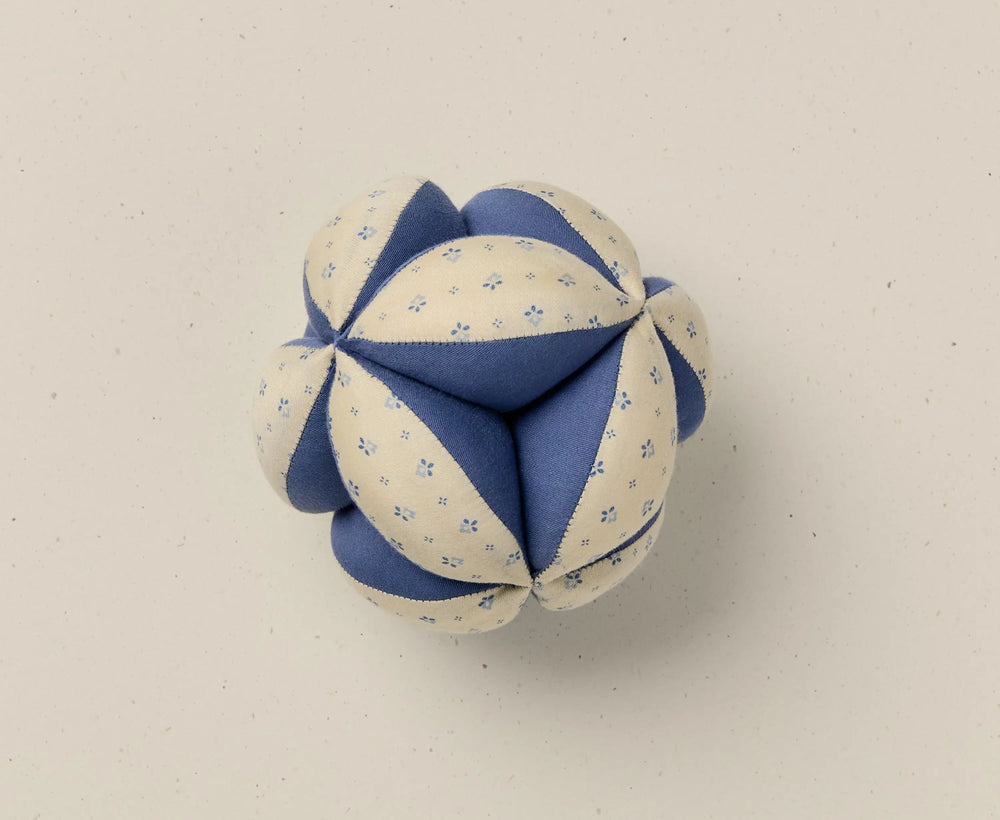 Blue and white fabric ball on a beige background