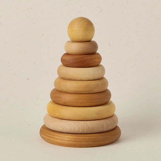 Wooden stacking ring toy on a beige background