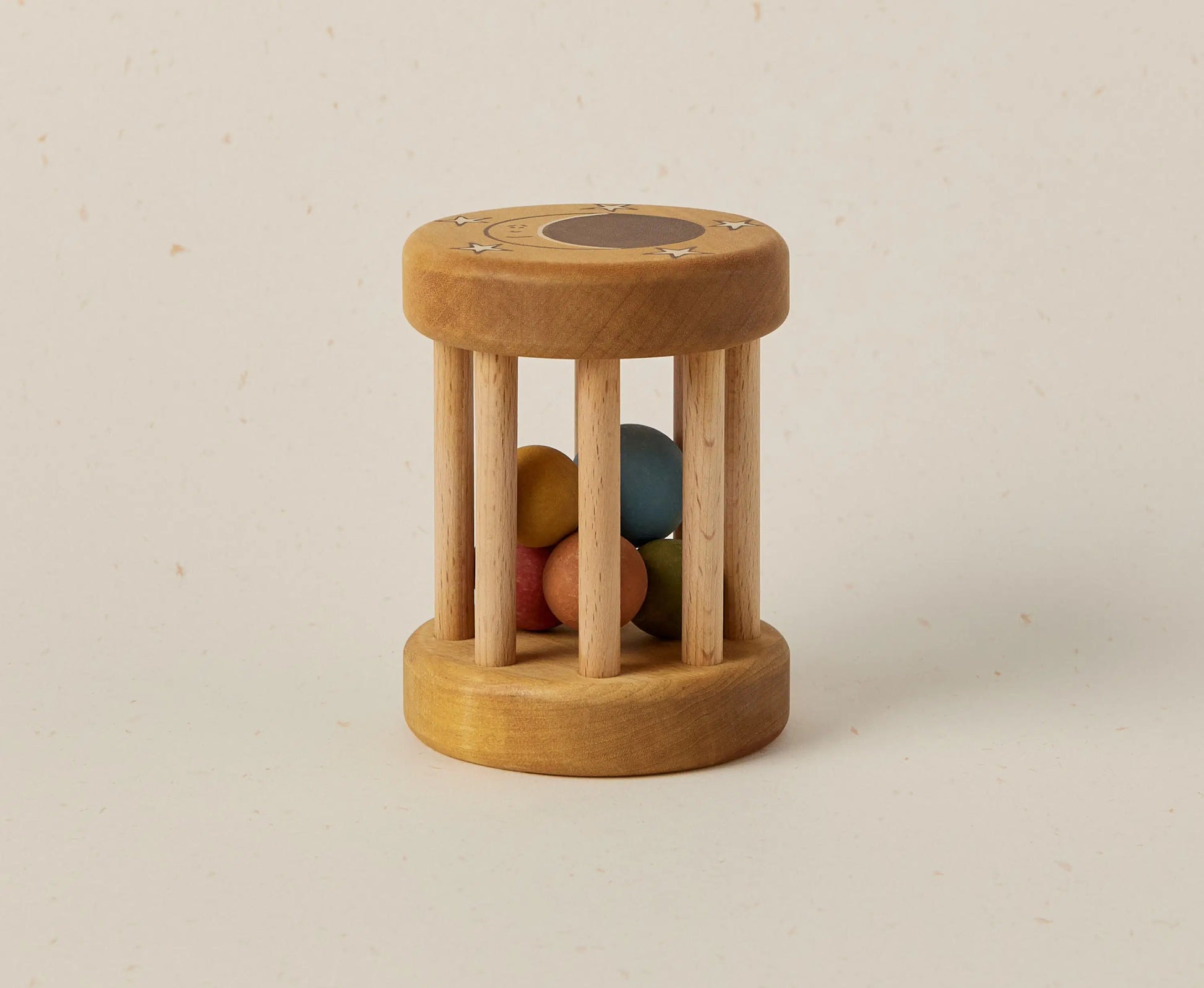 Wooden toy with colorful beads inside on a beige background