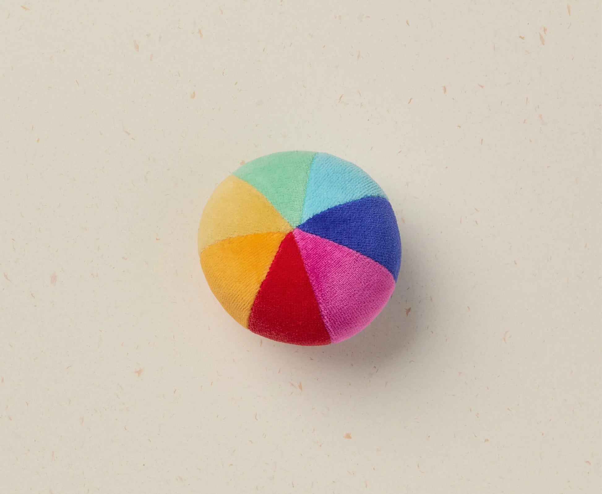 Multicolored ball on a beige background