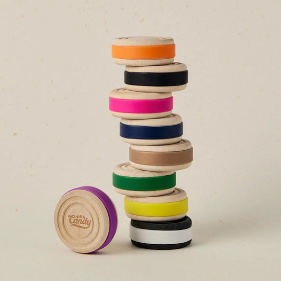 Stack of colorful wooden rings on a beige background