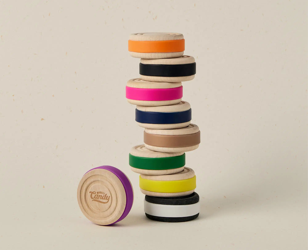 Stack of colorful wooden rings on a beige background