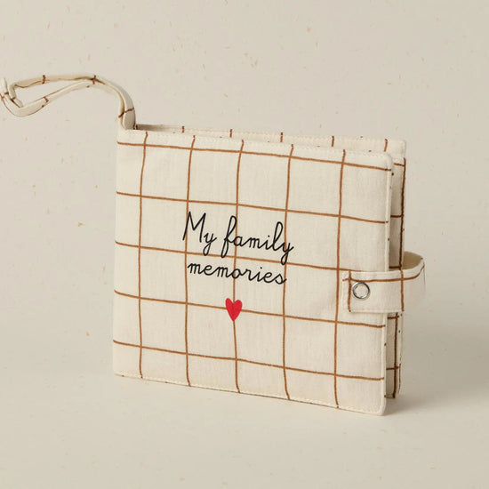 Plaid notebook with 'My family memories' text and red heart on a beige background