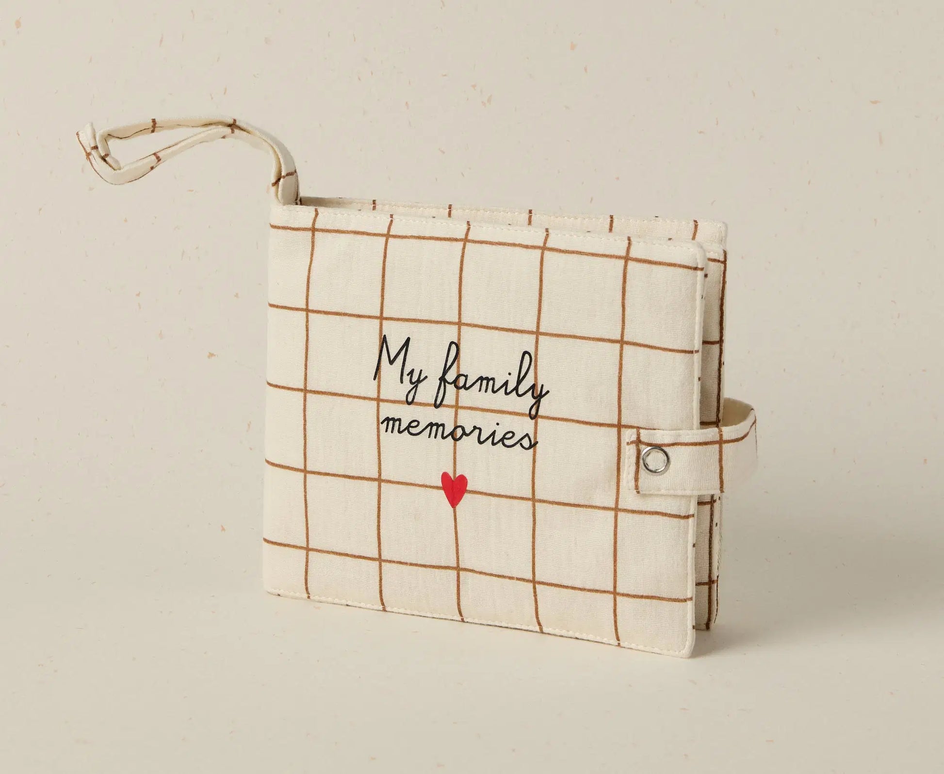 Plaid notebook with 'My family memories' text and red heart on a beige background