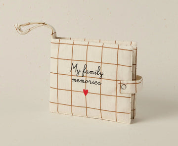 Plaid notebook with 'My family memories' text and red heart on a beige background