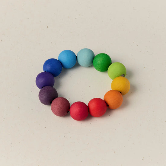 Colorful beaded bracelet on a light beige background