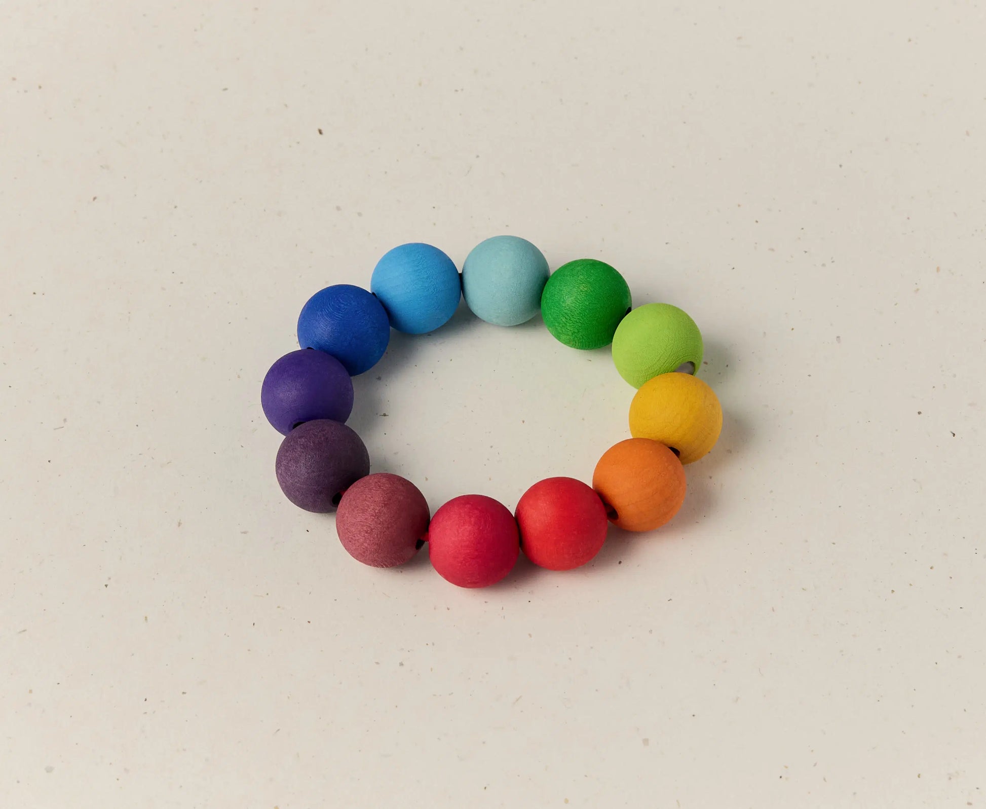 Colorful beaded bracelet on a light beige background