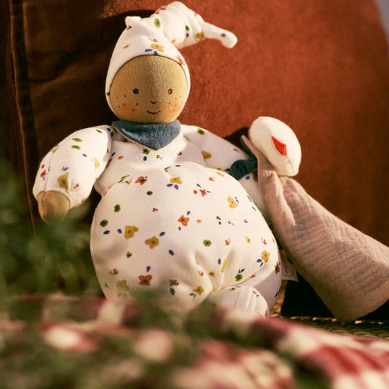Stuffed Waldorf doll with a soft focus background