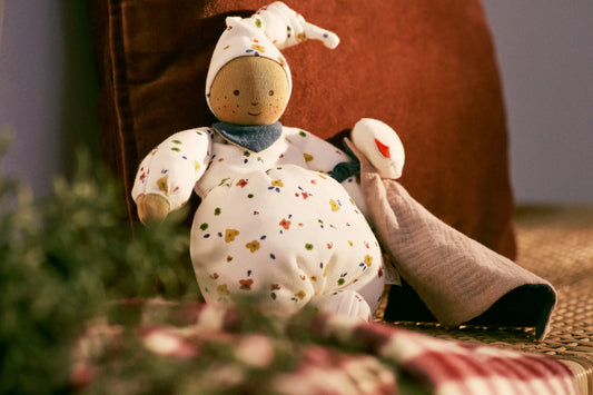 Stuffed Waldorf doll with a soft focus background