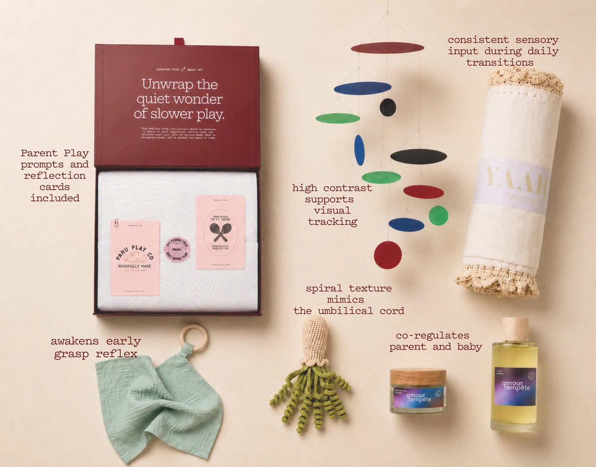 Collection of baby products including cards, toys, and a oil bottle on a beige background